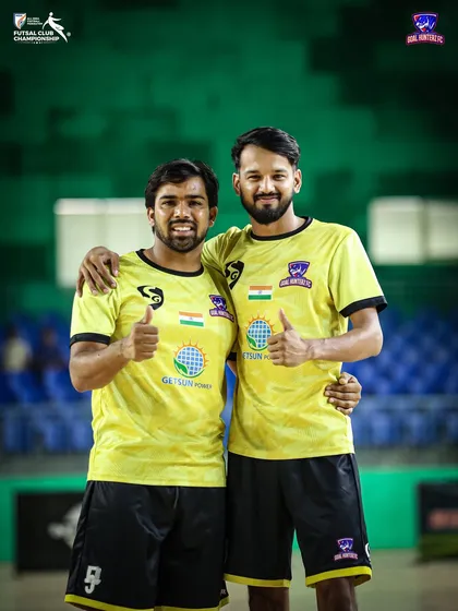 Two players giving a thumbs-up to the camera, celebrating their spot in the final.