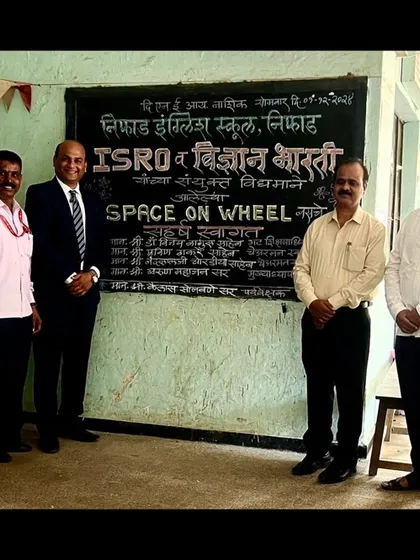 Standing with fellow educators in front of my welcome art for the ISRO 'Space on Wheel' event. Such collaborations help bridge the gap between art and science for students.