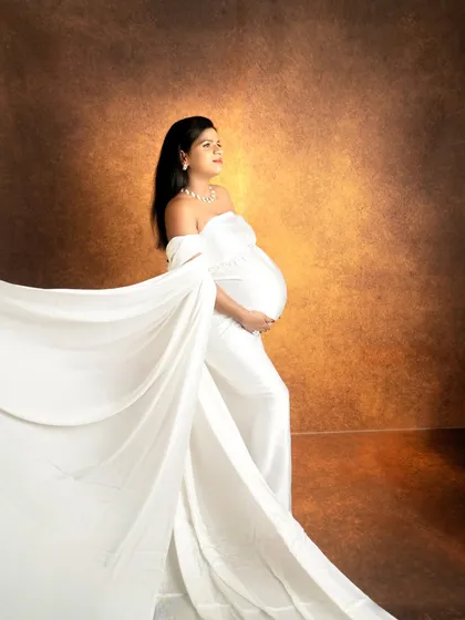 The color version of the fine-art drape shot, showing how a simple change to a textured, warm backdrop can alter the mood of the portrait.