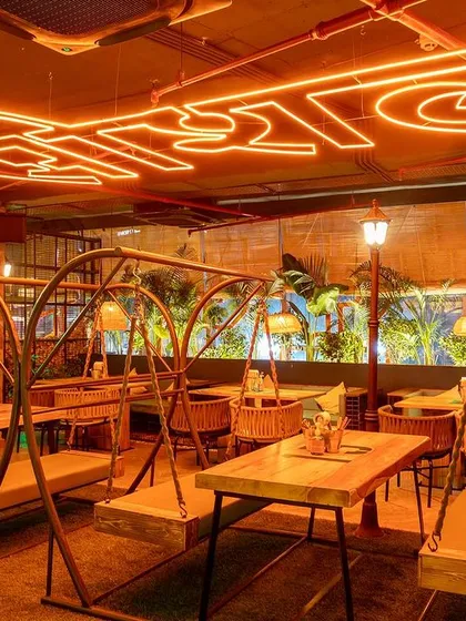 Capturing the unique ambiance of the new Social Offline in Gurugram. The swing seating and vibrant neon sign create a lively atmosphere that I aimed to translate into a single, inviting photograph.