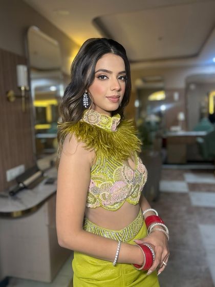 The side profile shows how the makeup and hair work together to create a polished and elegant look.