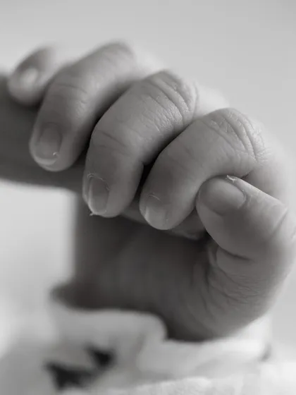 The tiniest details hold the biggest love. This close-up of a newborn's hand gripping a parent's finger is a powerful reminder of how small they once were, a precious memory to cherish.