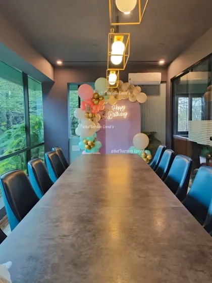 A small, tasteful balloon decoration in a corporate meeting room. This shows how I can add a festive touch to any space, big or small.