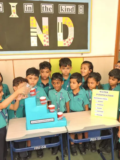 This close-up view shows the students' focused attention as they observe the results of their science experiment, sparking a love for inquiry-based learning.