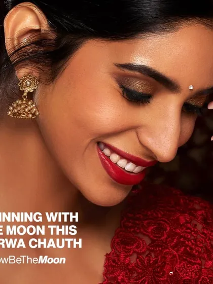 A stunning festive look for a client celebrating Karwa Chauth. The deep red lipstick is perfectly complemented by flawless, neutral gel nails, creating a timeless and elegant style.