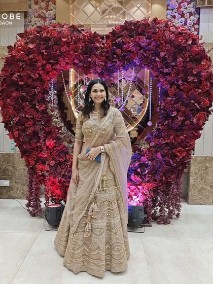 A full view of the happy client in her elegant beige lehenga. The tassels and the intricate work make it a standout piece.