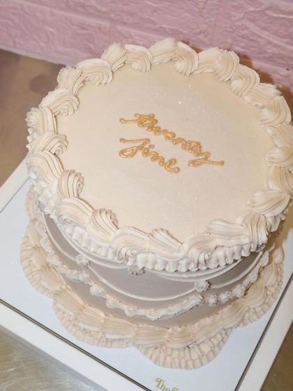A top-down view of our "twenty fine" cake, highlighting the beautiful swirls and clean finish of the vintage piping work.