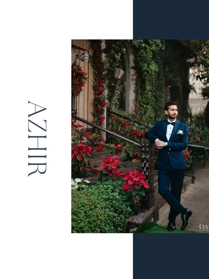 A stylish groom portrait against a backdrop of lush greenery and red poinsettias. The composition and colors make this a striking and memorable shot.