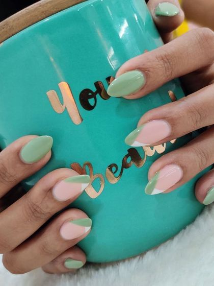 Pastel green is a perfect color for a modern French manicure. This design combines solid green nails with negative space and abstract tips for a chic, everyday look.