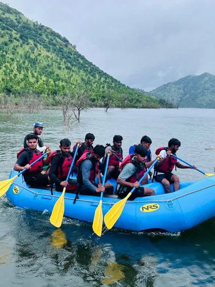 A full raft of participants practices paddling together, building the teamwork needed for more challenging waters.