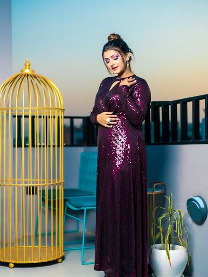 A different pose from the same shoot, highlighting the shimmer of the dress and the intensity of the coordinated purple eye makeup.