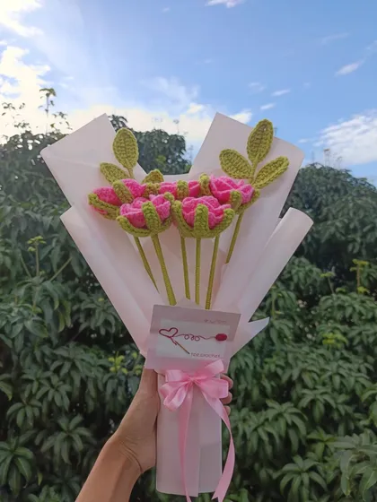 A custom-wrapped bouquet of pink roses.