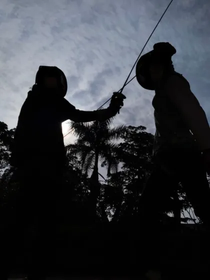 The silhouette of two fencers locked in a duel against the sky. This image represents the focus, discipline, and warrior spirit we instill in every athlete at our club.