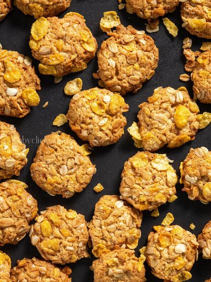 A top-down pattern of cornflake cookies, creating a visually interesting and textured background.
