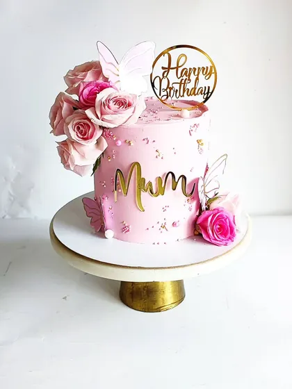 Another angle of the pretty pink cake for 'Mum', showing the fresh roses and elegant gold toppers.