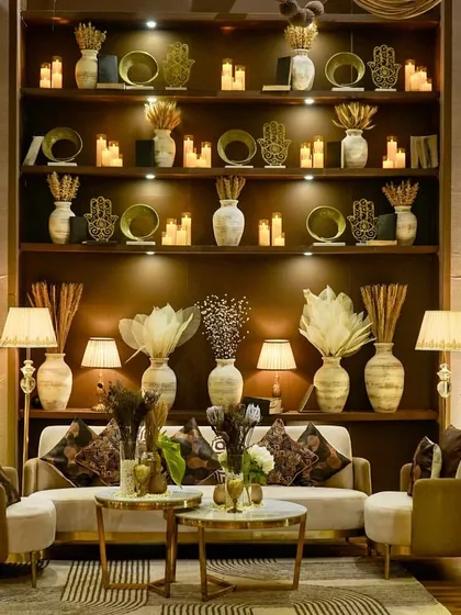We designed this sophisticated lounge for a cocktail evening with a 'Mocha Mousse' color palette. The setting features a grand, fully-stocked back bar with earthen decor, plush seating, and warm ambient lighting, creating an inviting and elegant space for guests to relax and connect.
