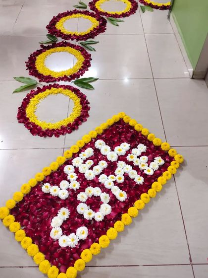 Welcome the new bride home with a beautiful floral path. I create custom 'Griha Pravesh' decorations like this 'Welcome' message and rangoli made from fresh flower petals to make her first steps into her new home memorable.