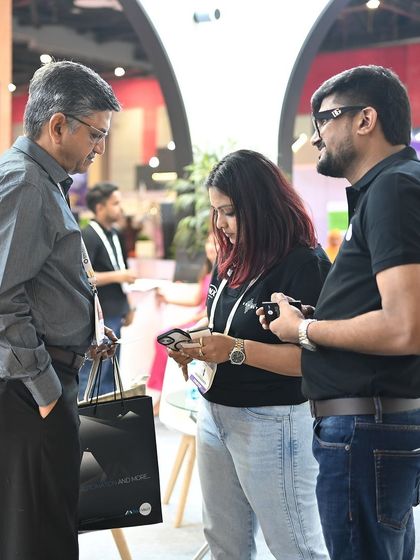 Our directors showing a visitor our control app on a smartphone. We focus on making our technology accessible and easy to use for everyone.