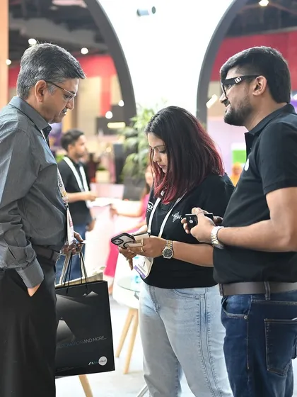 Our directors showing a visitor our control app on a smartphone. We focus on making our technology accessible and easy to use for everyone.