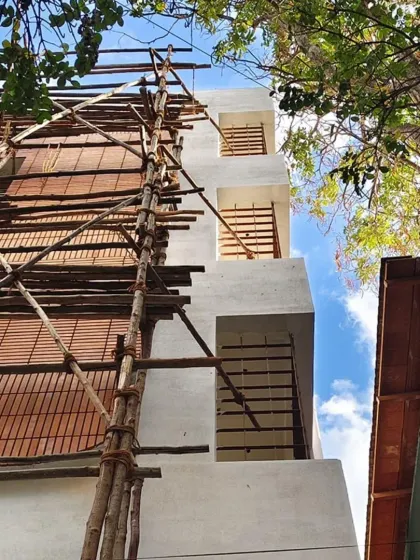 Another view of the 'Kutumb' project under construction, looking up at the facade.