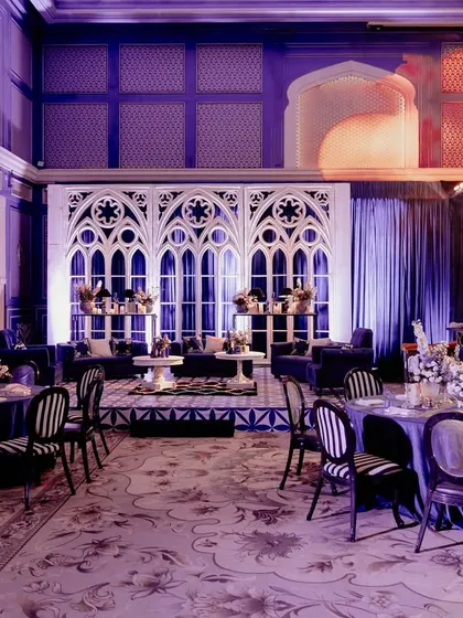 For Neomi and Rakshit's Sangeet, we designed a dramatic 'Gothic Palace Ball'. The hall was transformed with bold structures, Gothic arches, and a moody blue and purple lighting scheme, creating a sophisticated and high-energy celebration.