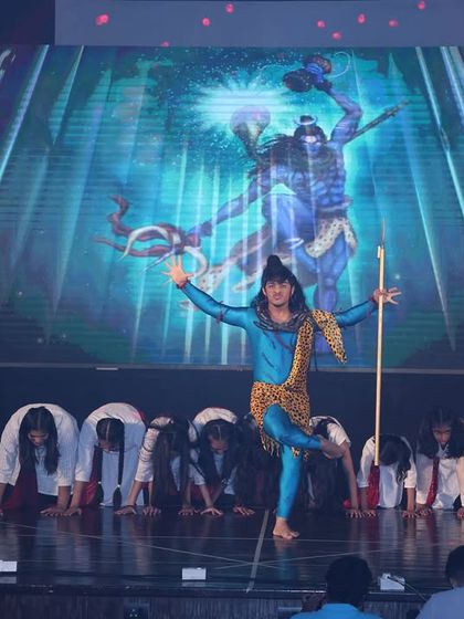 A solo performer embodying Lord Shiva, with a stunning digital backdrop enhancing the mythological theme of the act.