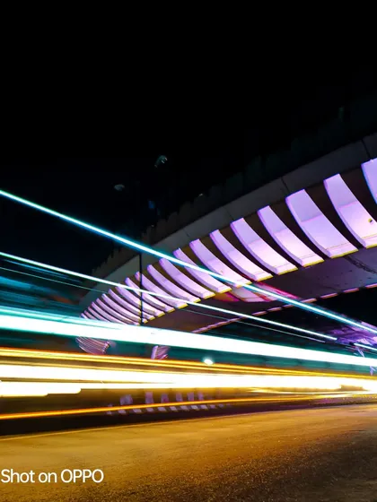 This version of the long-exposure bridge shot captures a mix of blue and white light trails, resulting in a clean, high-tech feel.