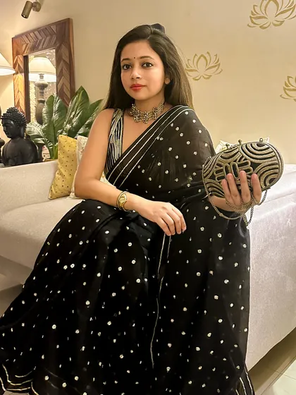 A relaxed pose on the couch, showing the versatility of the saree. You can look glamorous while still feeling comfortable enough to enjoy the event.