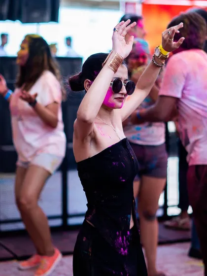 A stylish attendee enjoying the music at Holi Utsav. Our events attract a fashionable and energetic crowd.