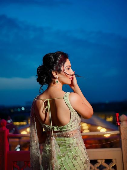 Another beautiful shot from the back, highlighting the hairstyle and the delicate tie-up detail of the blouse.