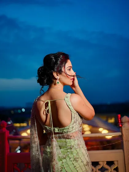 Another beautiful shot from the back, highlighting the hairstyle and the delicate tie-up detail of the blouse.