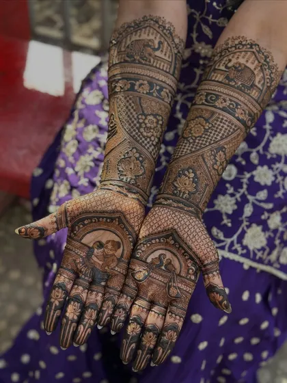 Both hands together, showing the complete custom design with the aaji portrait and other traditional motifs like elephants and lotuses.