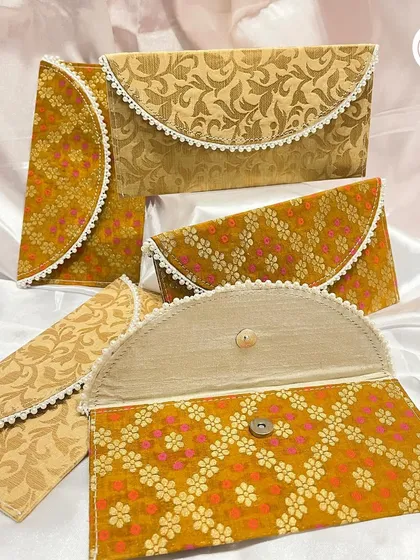 A collection of our custom fabric envelopes, shown in different brocade patterns. Perfect for gifting cash or vouchers in style.
