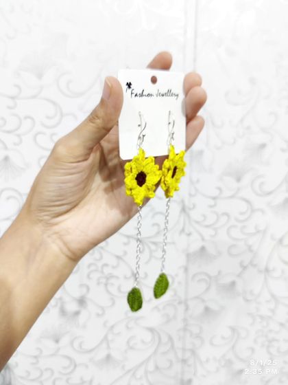 My popular dangling sunflower earrings. These feature a bright yellow sunflower top with a delicate chain leading to a small crocheted leaf.