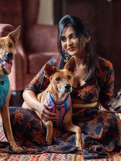 Another beautiful group shot of a woman and her beloved indie dogs, showcasing their unique personalities and the strong bond they share.