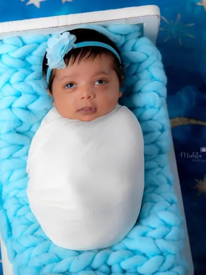 Look at that little eye roll! This 20-day-old newborn girl is already showing off her personality in this dreamy moon and stars setup.