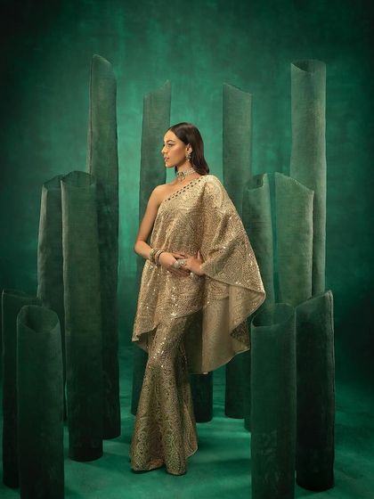 A full-length shot of an embellished cape and sharara set from 29 India, creating a statuesque look.