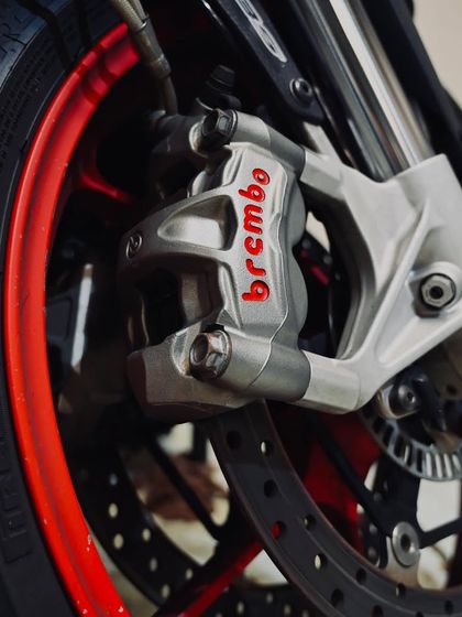 A close-up of the Brembo brake calipers on an Aprilia, a crucial component for serious stopping power.