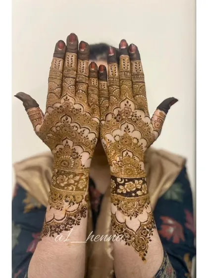 A full view of the intricate Pakistani henna design, showing the detailed work on both hands. This is a classic look for brides and wedding guests.