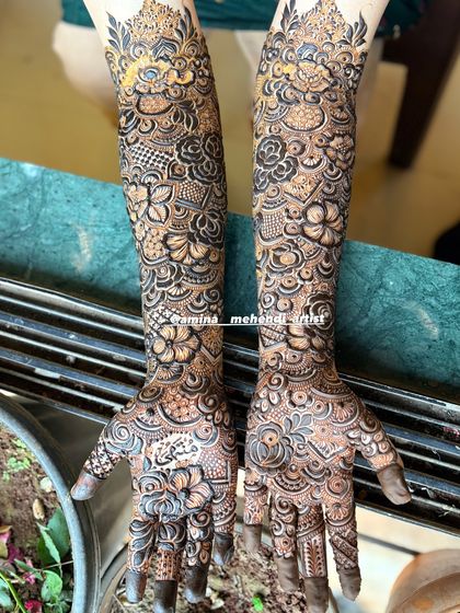 The combination of delicate vines and bold floral work gives this design a unique and captivating look.