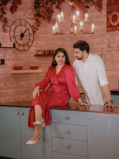 A cozy and stylish shot in our modern kitchen set. The bride's satin dress and the warm lighting create an intimate and chic pre-wedding photo.