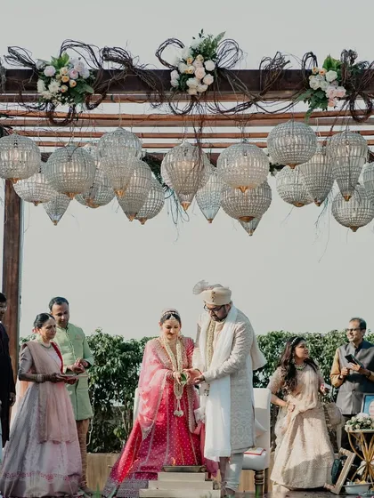 Another angle of the rustic-chic mandap, showing the contrast between the natural wood and the glamorous crystals.