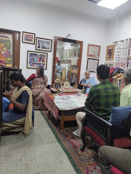 Another view of the design students' visit. Here, a student is learning on a traditional floor loom, connecting with the roots of textile creation.