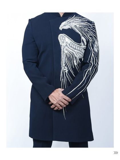 A full frontal view of the navy bandhgala jacket. The asymmetrical placement of the phoenix embroidery gives it a contemporary edge, perfect for a fashion-forward guy.