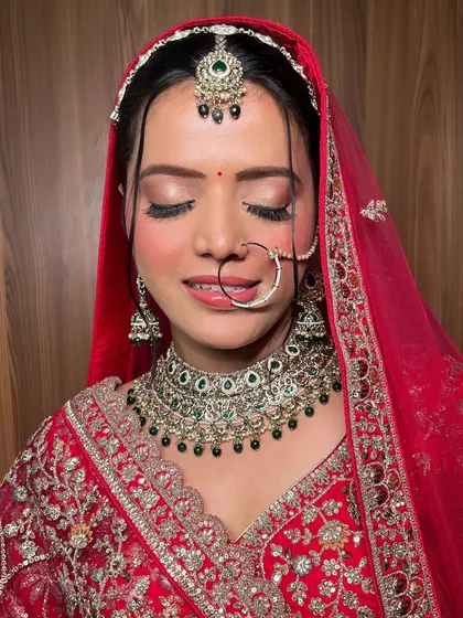A detailed shot of the eye makeup for this classic North Indian bridal look. The soft, blended eyeshadow and perfect lashes enhance her eyes beautifully, even when closed.