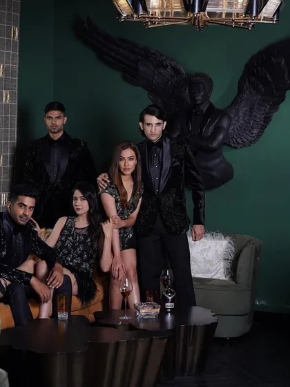 A group of models showcasing our 'Stars of the Night' collection. This image captures the sophisticated and glamorous aesthetic we aim for in both our men's and women's evening wear.