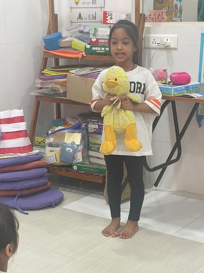 This student chose her favorite stuffed duck for "Share and Shine." Bringing a personal object helps children feel more confident and gives them a clear topic to talk about.