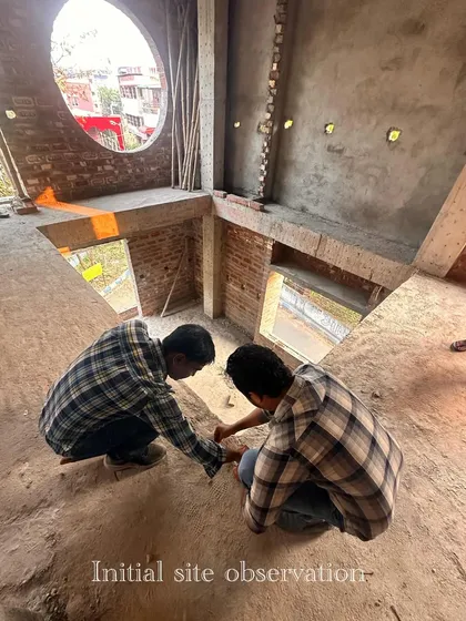 My team conducting an initial site observation in a space with a unique circular window.