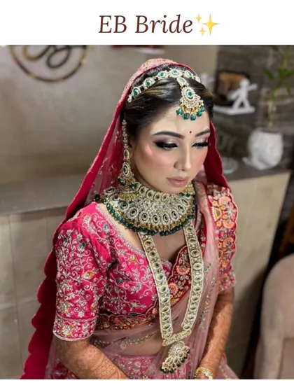 A full view of one of our beautiful brides. The makeup is designed to be picture-perfect from every angle, with a focus on creating a balanced and harmonious look that complements her jewelry and pink lehenga.