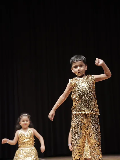 It's not just for girls. This young man from the 'Little Champs' group shows off his powerful moves and stage presence during the performance.